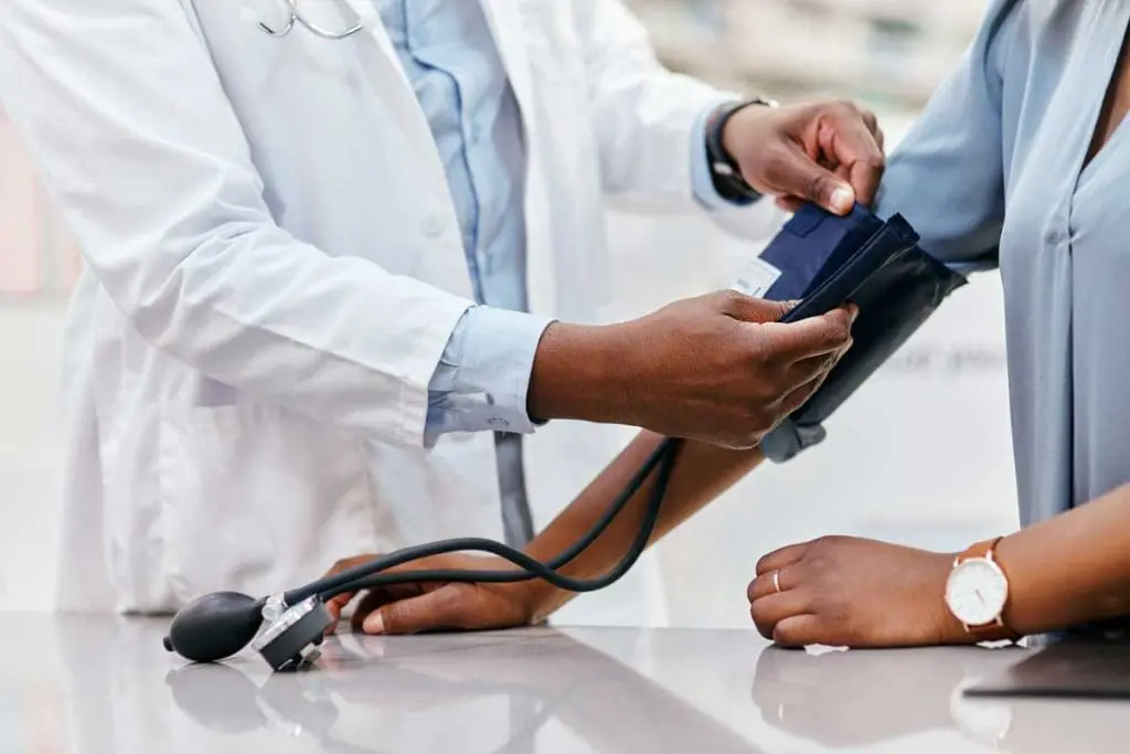 Doctor measuring patient's blood pressure, an important part of the OGUK Medical examination process