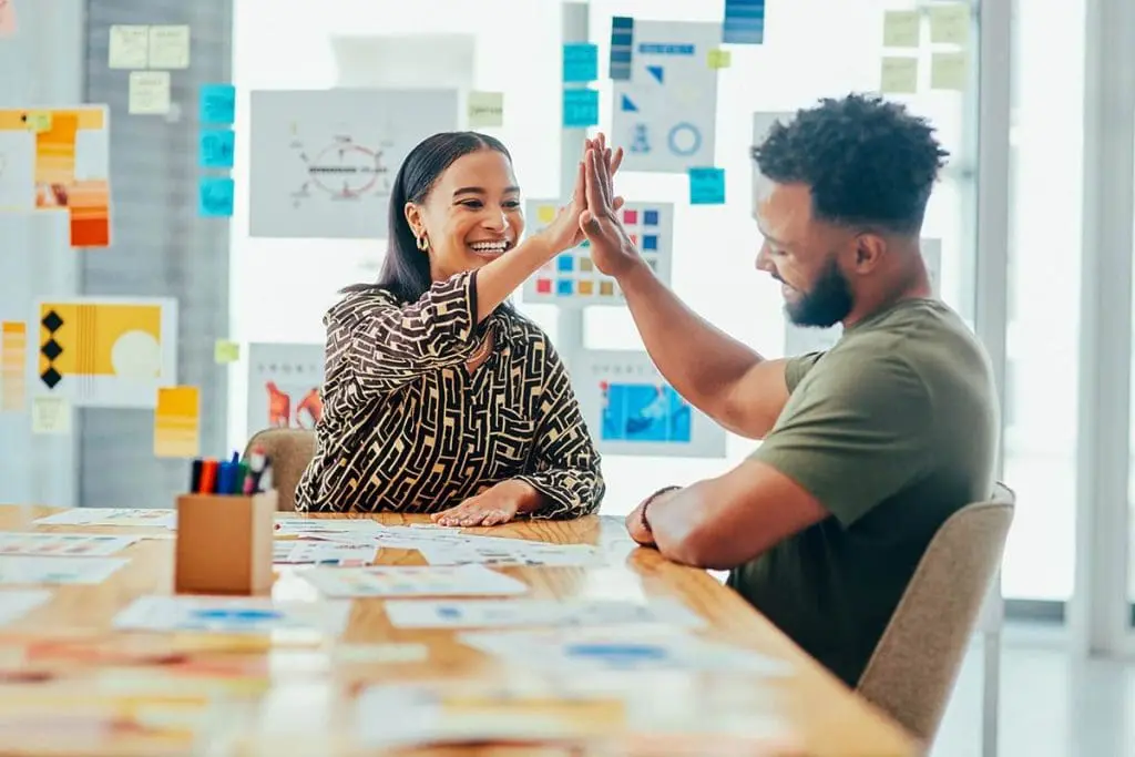 High-five celebrating mental health awareness achievements