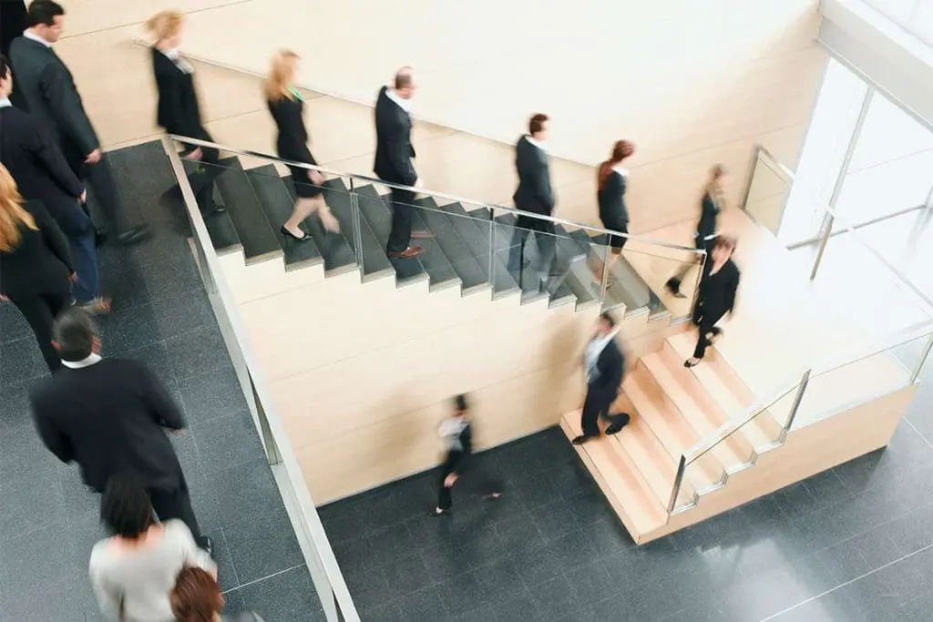 Office workers moving around in a corporate setting.