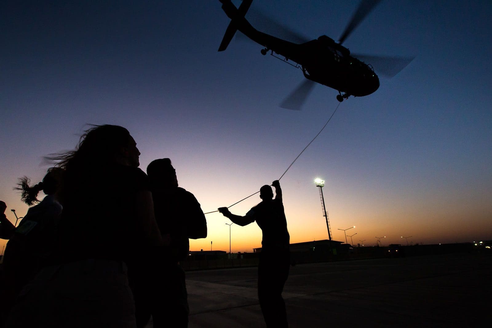 Helicopter with people on the ground