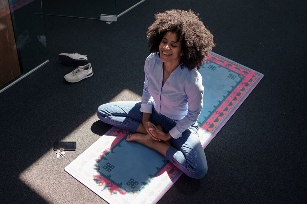 Office worker meditating on a yoga mat
