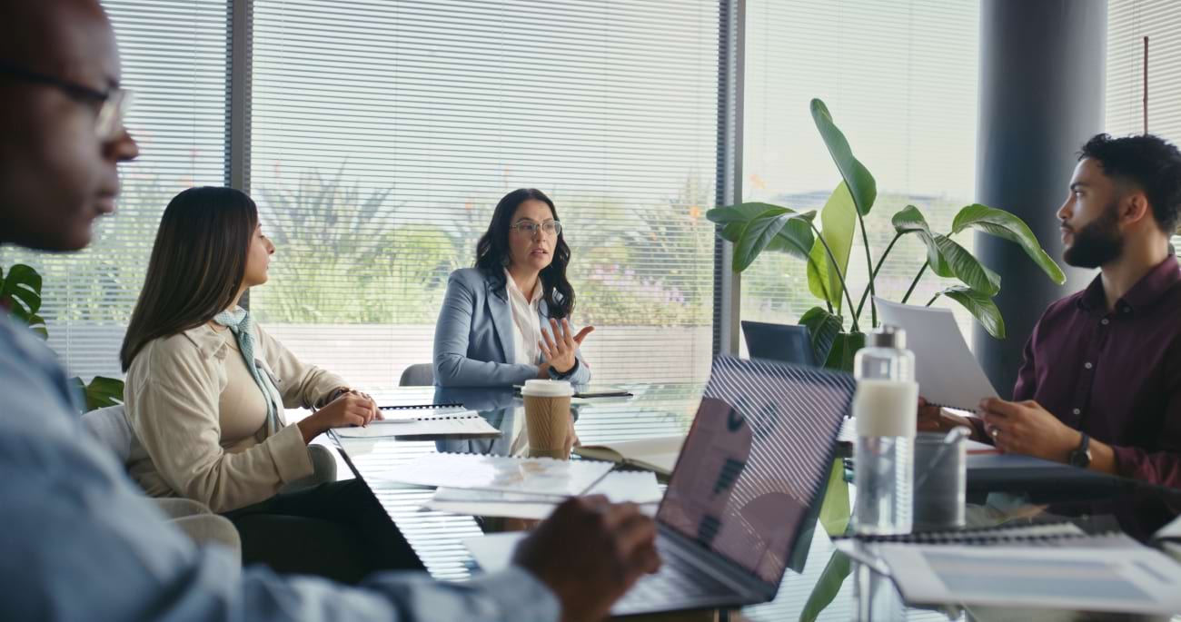 Business team discussing workplace risk management strategies in a meeting room
